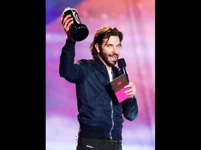 Actor Bradley Cooper accepts the award for Best Kiss he shares with actress Jennifer Lawrence for Silver Linings Playbook at the 2013 MTV Movie Awards in Culver City, California. He also won the Best Male Performance for Silver Linings Playbook. (Reuters Images)