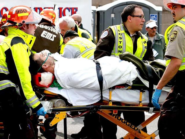 A man is loaded into an ambulance after he was injured by one of two bombs exploded during the 117th Boston Marathon near Copley Square in Boston, Massachusetts. AFP
