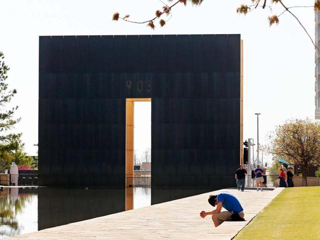 Shane Magness, a student at Oklahoma Christian University, bows his head in prayer for the victims of the Boston Marathon bombing, at the Oklahoma City National Memorial in Oklahoma City. AP Photo/Sue Ogrocki