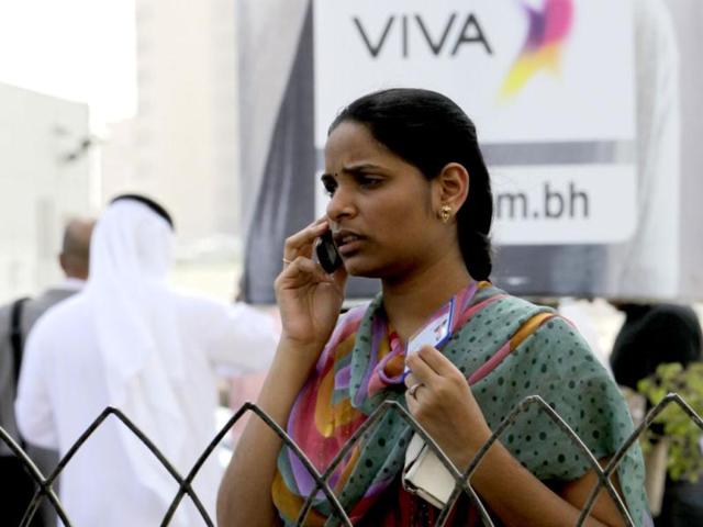 A woman speaks on the phone after evacuating from her office building following tremors in central Manama in Bahrain following a major earthquake in Iran near the border with Pakistan. Reuters
