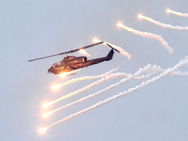 An AH-1W Attack Helicopter launches flares during Han Kuang military exercises in Penghu county, Taiwan. (AP)