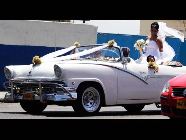A bride rides a convertible car during a wedding celebration in Havana. (Reuters)
