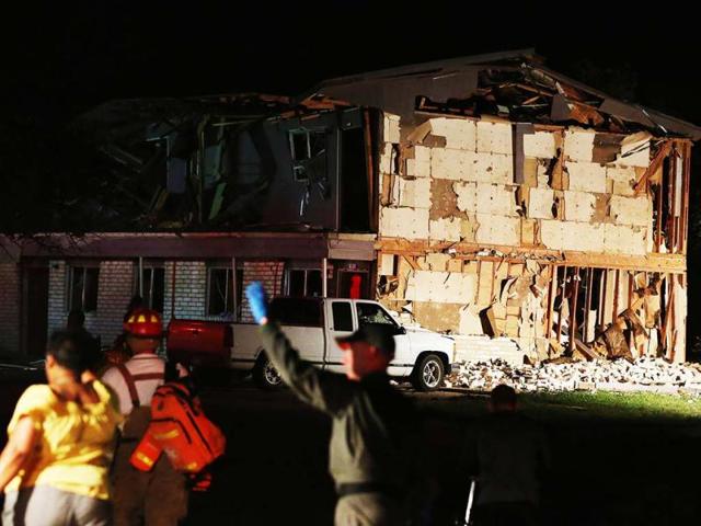 Rescue workers work near a damaged apartment complex after a nearby fertilizer plant exploded in West, Texas. AP photo
