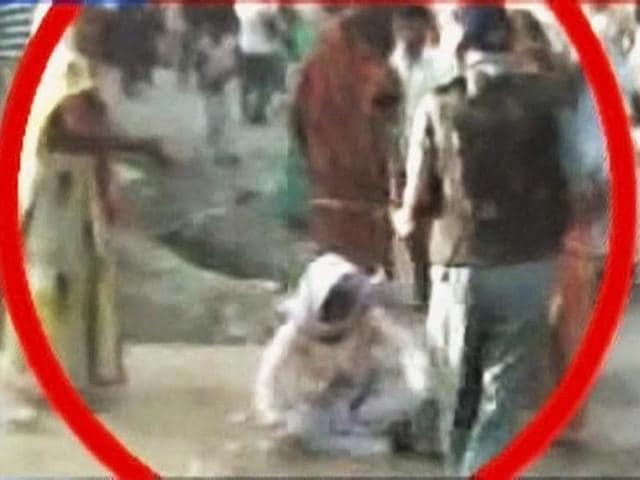 An-old-woman-who-was-thrashed-by-a-cop-during-a-demonstration-over-the-alleged-rape-and-murder-of-a-six-year-old-girl-in-Aligarh-Uttar-Pradesh-PTI-Photo-TV-grab