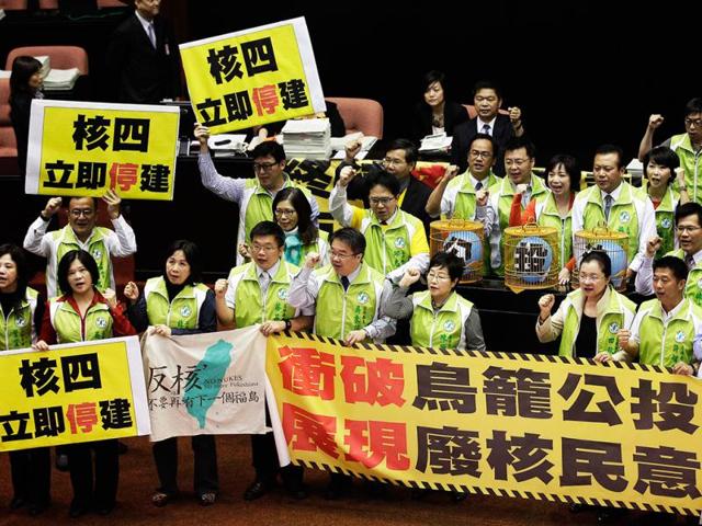 Legislators from the opposition Democratic Progressive Party (DPP) shout slogans during a protest at the parliament in Taipei. Reuters
