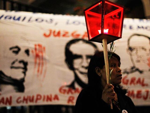 A woman holds a candle lamp during a demonstration against the suspension of the genocide trial of former Guatemalan dictator Efrain Rios Montt, outside the Supreme Court of Justice in Guatemala City. Reuters