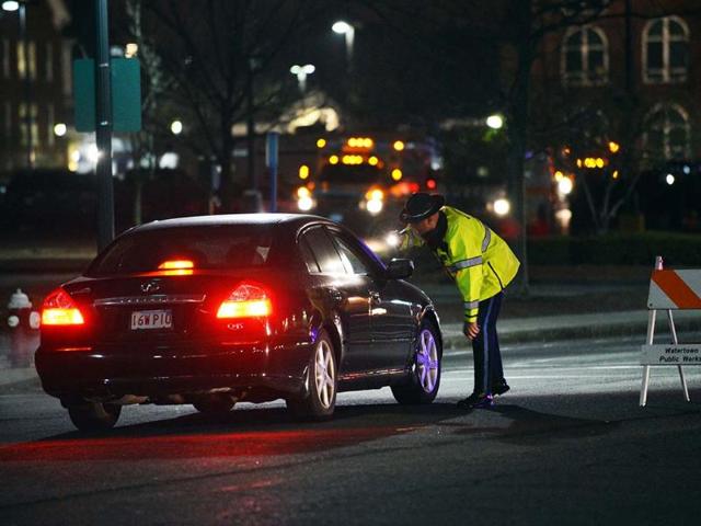 A police officer checks a driver at a check point as a search for the second of two suspects wanted in the Boston Marathon bombings takes place in Watertown, Massachusetts. (AFP)