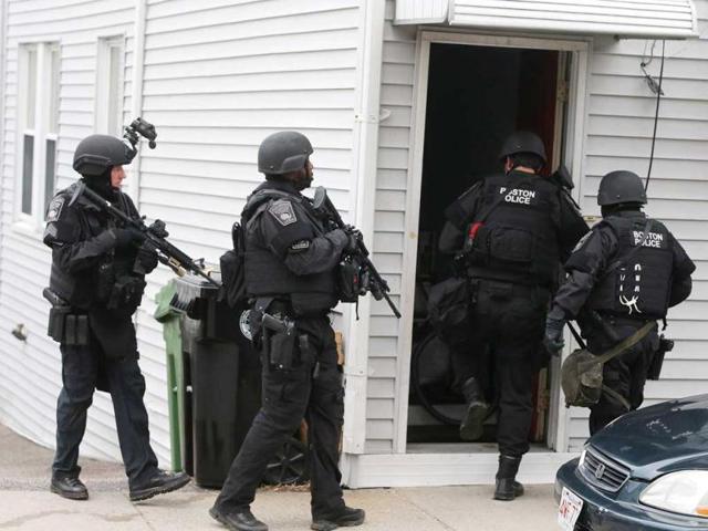 SWAT team members search for one remaining suspect at a residential building in Watertown, Massachusetts. AFP photo