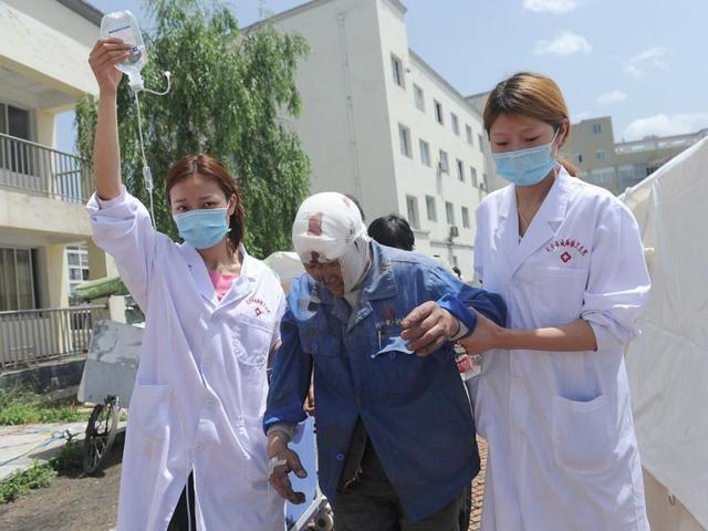 Nurses help an injured man at a temporary treatment station following an earthquake in Lushan county in Ya'an in southwest China's Sichuan province. AP