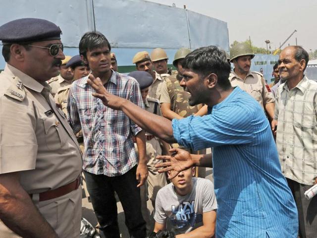 A demonstrator argues with a police officer during a protest outside police headquarters in New Delhi against the rape of a five year old. Reuters