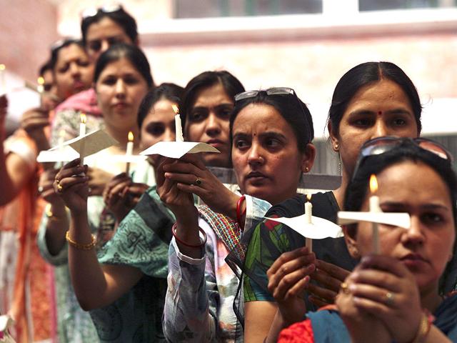 Demonstrators hold candles during a prayer meeting for a five-year-old rape victim in Jammu. Reuters