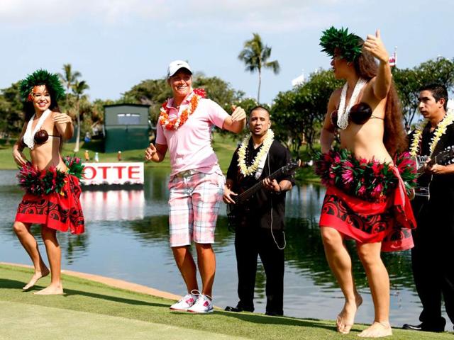 Suzann Petersen of Norway dances with hula dancers after winning the LPGA LOTTE Championship Presented by J Golf at the Ko Olina Golf Club in Kapolei, Hawaii. AFP
