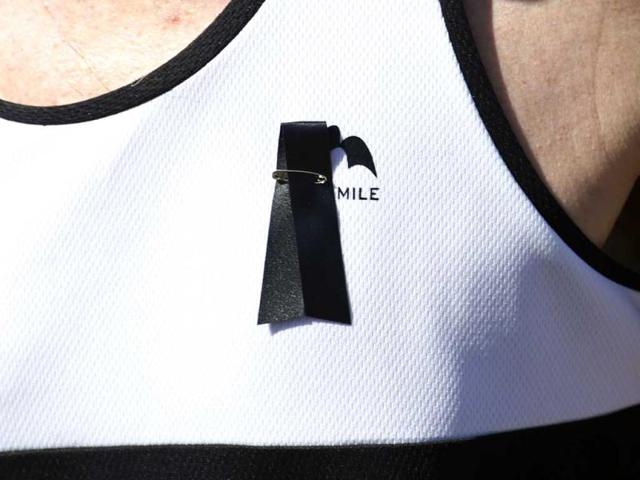 A runner wears a black ribbon in memory of the victims of Boston Marathon bombings starts the race during the London Marathon. AP Photo