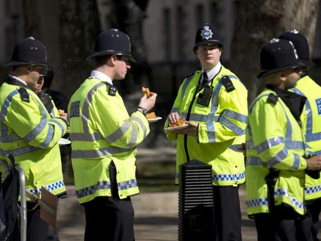 British police officers grab a bite near the route of the London Marathon. The London Marathon started in defiant mood on a glorious sunny morning Sunday despite concerns raised by the bomb attacks on the Boston Marathon six days ago. London's is the first major international marathon since the double bomb attack near the finish line in Boston, which left three people dead and more than 170 injured, including many who are still hospitalized. AP Photo