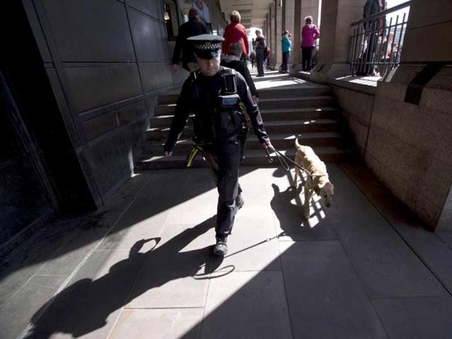 Max, a member of a British police explosive dog search team patrols with his handler outside Westminster station beside the route of the London Marathon. The London Marathon started in defiant mood on a glorious sunny morning Sunday despite concerns raised by the bomb attacks on the Boston Marathon six days ago. London's is the first major international marathon since the double bomb attack near the finish line in Boston, which left three people dead and more than 170 injured, including many who are still hospitalized. AP Photo