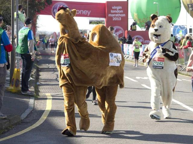 Fun runners dressed as a camel and a dog, set off at the start of this year's Virgin London Marathon, at the Green Start Line, in Greenwich Park, east London. AP Photo