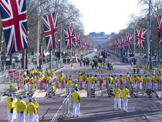 Volunteers in bright yellow get ready prior to the London Marathon in the Mall in London, Sunday, April 21, 2013. Security has been stepped up in London following the recent bombs at the Boston Marathon. The London Marathon started as planned on a glorious sunny morning Sunday despite concerns raised by the bomb attacks on the Boston Marathon six days ago. AP Photo