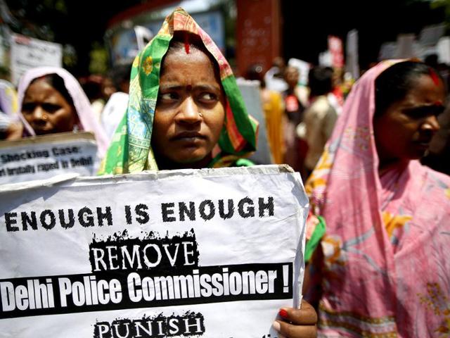A woman holds a poster as she protests with others against how authorities handle sex crimes near the Parliament in New Delhi. (AP)