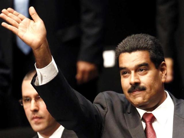 Venezuela's President Nicolas Maduro waves to supporters as he arrives at the oath-taking ceremony of new cabinet ministers in Caracas. (Reuters)