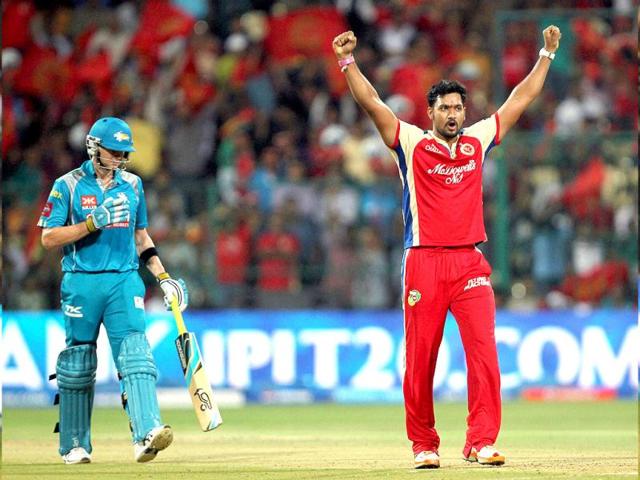 RCB bowler Ravi Rampaul celebrates the wicket of Pune Warriors' Steven Smith during the T20 match at Chinnaswamy Stadium in Bangalore. (PTI)