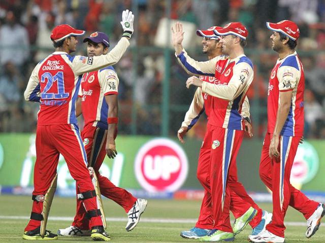 Royal Challengers Bangalore team celebrate after the dismasal of Pune's Yuvraj Singh during the T20 match in Bangalore. (Sanjeev Verma/HT)