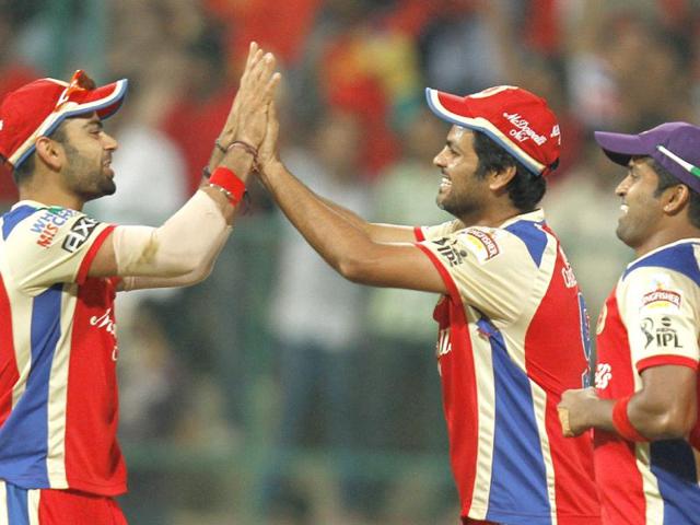 Royal Challengers Bangalore captain Virat Kohli celebrates with RP Singh after taking the catch of Pune Warriors India batsman Robin Uthappa during T20 match in Bangalore. (Sanjeev Verma/HT)