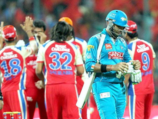 Pune Warriors' Yuvraj Singh walks back to pavilion after his dismissal during the T20 match against RCB at Chinnaswamy Stadium in Bangalore. (PTI)