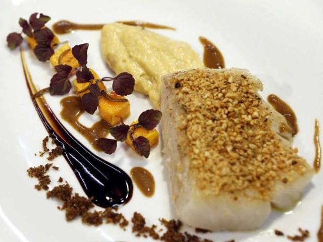 Picture taken in Nice, southeastern France, of a dish "Dos de cabillaud pane aux arachides" (Back of cod breaded with peanuts), prepared by French Michelin-starred Chef David Faure at his restaurant "Aphrodite". Chef David Faure proposed dishes composed with worms and crickets. (AFP)