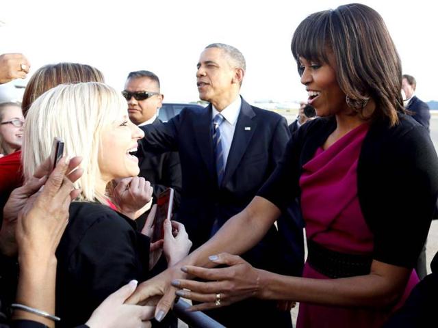 President Barack Obama and first lady Michelle Obama greet well wishers after they step off Air Force One at Dallas Love Field as they arrive to attend the George W Bush presidential library dedication and the memorial for victims of the fertilizer plant explosion in West, Texas. (AP Photo)