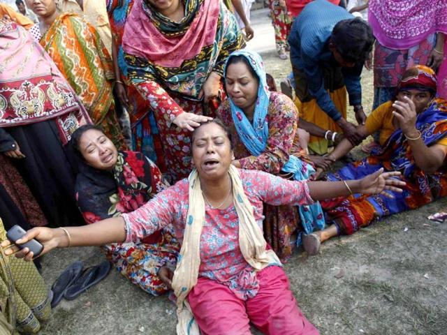 People mourn for their relatives, who are trapped inside the rubble of the collapsed Rana Plaza building, in Savar, 30 km (19 miles) outside Dhaka. (Reuters)