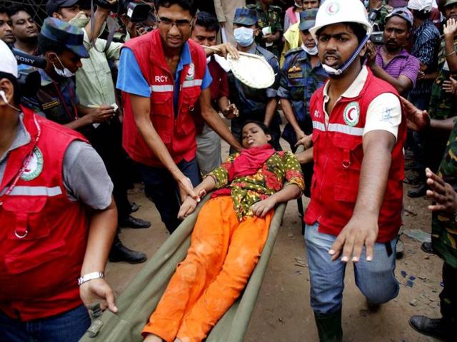Rescue workers carry a survivor, who was trapped inside the rubble of the collapsed Rana Plaza building, in Savar, 30 km (19 miles) outside Dhaka, Bangladesh. Reuters