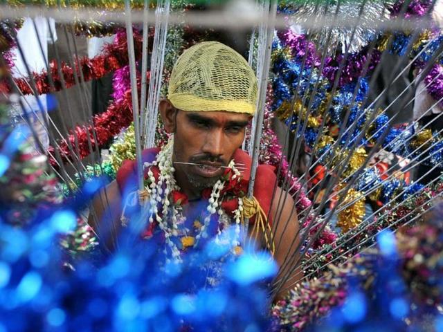A Hindu devotee has his body pierced during a Hindu festival in Yangon. Although only an estimated two per cent of Myanmar's population practice Hinduism in this majority Buddhist country, most of them being Myanmar Indians, Hindu influences can be found in the Myanmar language, culture and the architecture of cities such as Bagan. AFP PHOTO
