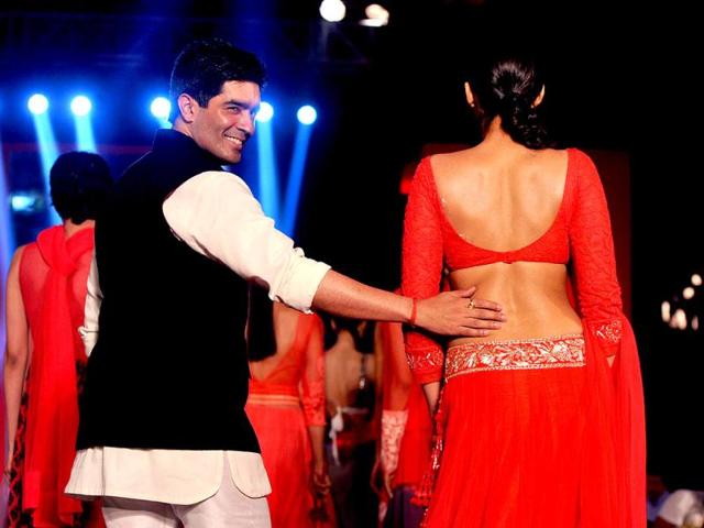 Sonam Kapoor shows her envious back as she walks the ramp with Manish Malhotra. AFP Photo