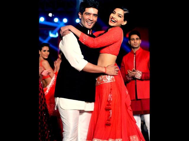 Sonam Kapoor shares a light moment with designer Manish Malhotra during a product launch in Mumbai on April 25. AFP Photo