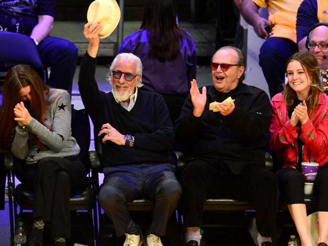 Record producer Lou Adler tips his hat beside actor Jack Nicholson as the Los Angeles Lakers take on the San Antonio Spurs in Game Three of the NBA Western Conference Quarterfinal Playoffs at Staples Center in Los Angeles, California. AFP PHOTO