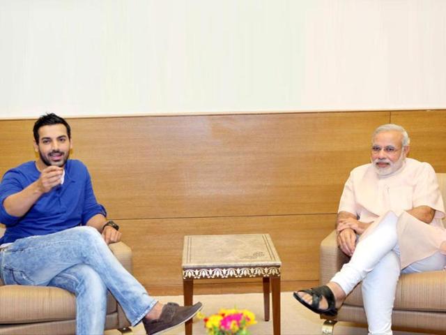 Gujarat Chief Minister Naredra Modi and Bollywood actor John Abraham at a meeting in Gandhinagar on Friday. (PTI Photo)
