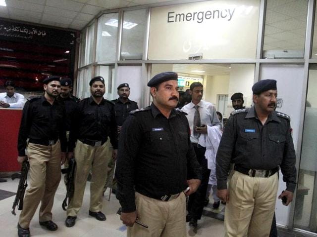 Pakistani police officers stand guard at an emergency ward where Sarabjit Singh is admitted at a local hospital in Lahore, Pakistan. AP