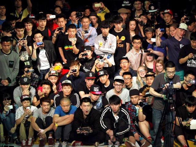People watch as a dancer performs during the 2013 B-BOY Shanghai breakdancing competition in Shanghai. Reuters
