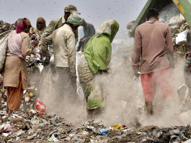 Rag pickers sort through the garbage and pick out recyclable materials to sell from the 70 acre Ghazipur landfill site in east Delhi. HT Photo/Raj K Raj 