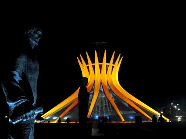 Brasilia's Metropolitan Cathedral is illuminated in orange in honor of Queen Beatrix of the Netherlands. (AFP)