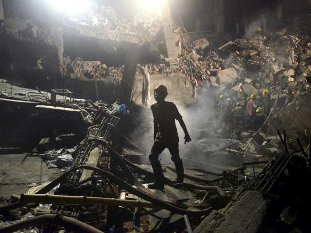 A worker leaves the site where a garment factory building collapsed near Dhaka, Bangladesh. (AP)