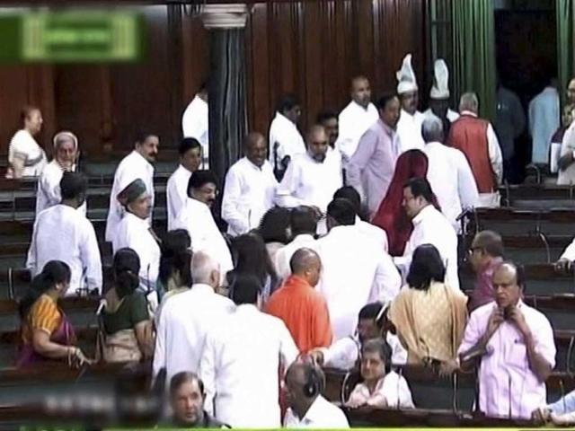 BJP members walk out of the Lok Sabha in New Delhi. (PTI/TV Grab)