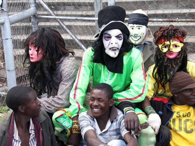 Traditional Nyau dancers are seen before their performance at the International Workers Day rally in Harare, Zimbabwe. (AP Photo)