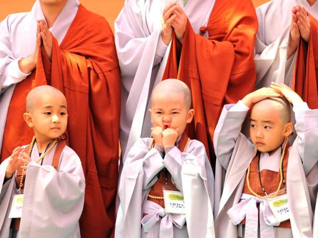 Young South Korean Buddhists with freshly shaved heads line up as they take part in a ceremony called "children becoming Buddhist monks" at Chogye Temple ahead of Buddha's birthday in central Seoul. AFP