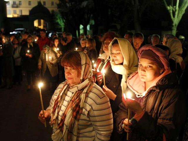 Lithuanian Orthodox Church believers hold candles during the Easter vigil mass at the Prechistensky, the Cathedral Palace in Vilnius, Lithuania. AP