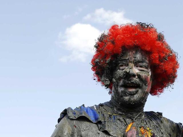 A competitor smiles near the finish of the Maldon Mud Race at the Blackwater River during low tide in Maldon. (Reuters)