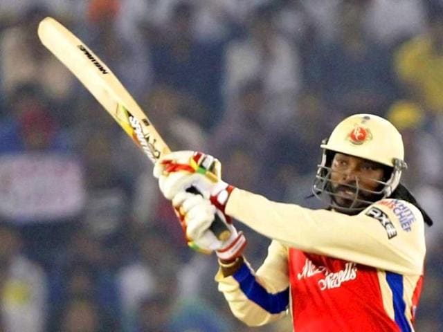 Royal Challengers Bangalore batsman Gayle plays a shot against Kings XI Punjab during the T20 league match at PCA Stadium in Mohali. PTI