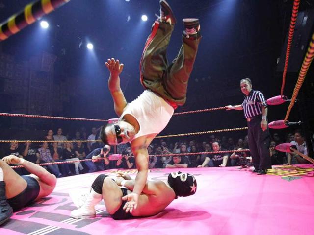 Lucha libre wrestler Cholitito leaps onto Mini Matt Classic during their fight at the Lucha Va Voom show as part of a Cinco de Mayo celebration at the Mayan theatre in Los Angeles, California. Reuters