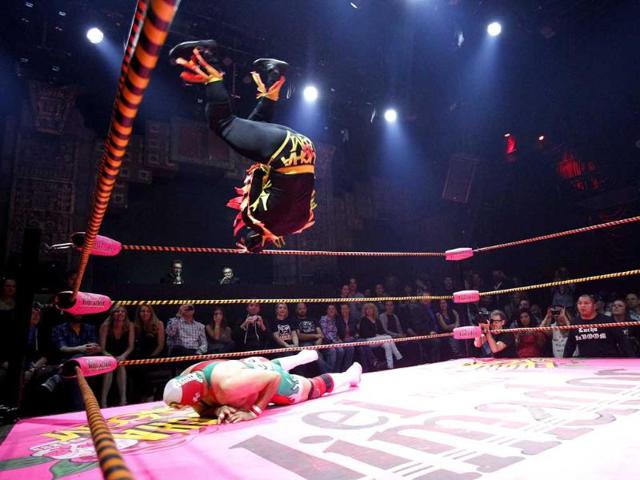 A lucha libre wrestler of The Crazy Chickens leaps in midair while fighting against Dr Maldad during the Lucha Va Voom show as part of a Cinco de Mayo celebration at the Mayan Theatre in Los Angeles, California. Reuters