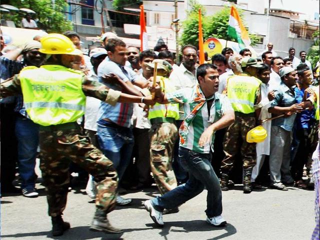 Security personnel try to stop Congress workers outside a counting centre for the Karnataka Assembly polls in Bengaluru. (PTI)
